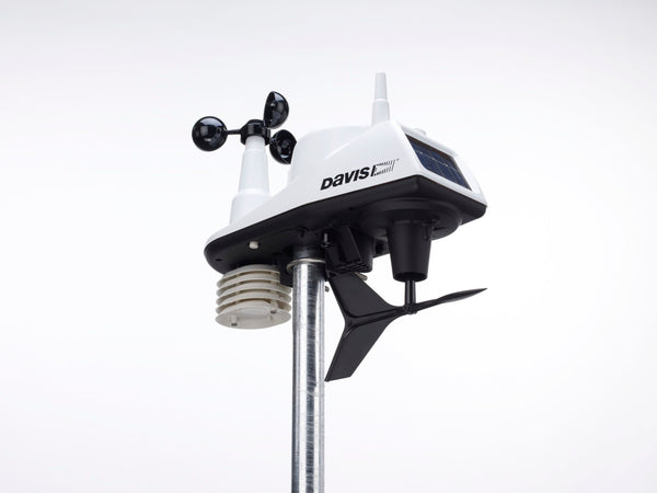 Wireless integrated weather station by Davis Instruments, mounted on a metal pole against a white background.