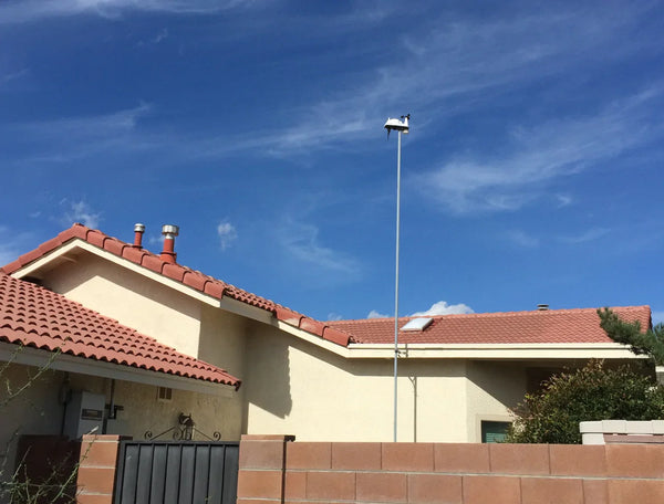 Wireless Vantage Vue weather station by Davis Instruments with sensors mounted atop a tall silver pole.
