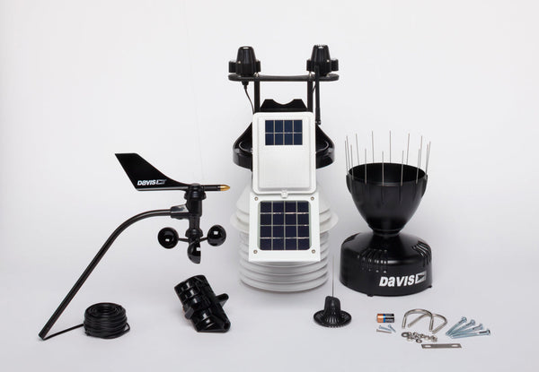 Wireless weather station with fan-aspirated radiation shield by Davis Instruments, featuring anemometer, rain collector, and solar panels.