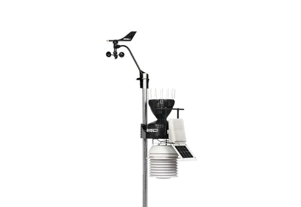 Weather station by Davis Instruments featuring an anemometer and solar radiation shield on a gray pole.
